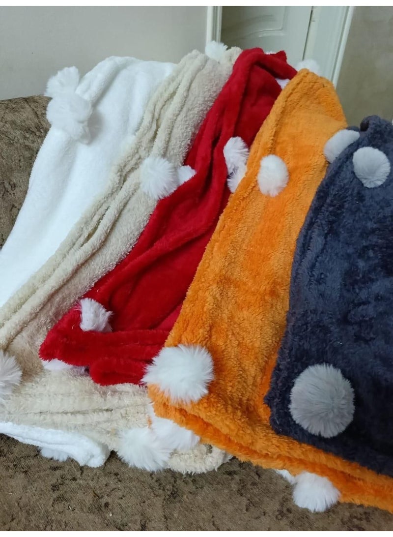 Exclusive and available now! Faux fur blanket adorned with plush pom-poms. Autumn and winter colors. We've also designed a matching rose-shaped cushion to add a touch of cheer to your home. Blanket size: 1 meter x 1.5 meters. Multiple colors available. - Image 1