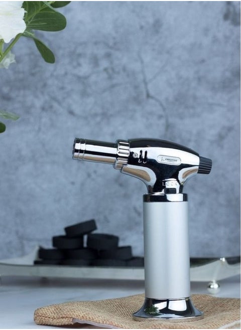 A luxurious silver charcoal lighter that can be filled again with a safety button to install the flame