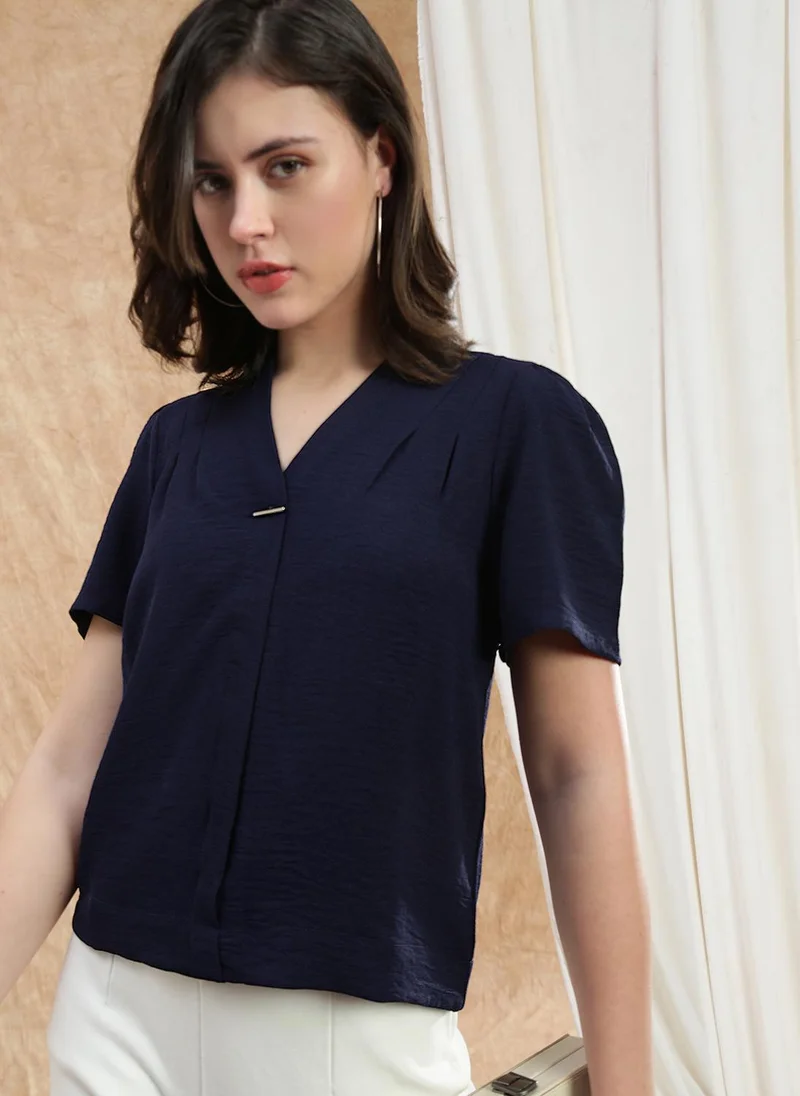 جلو باص بلوزة نسائية بياقة على شكل حرف  وأكمام منتفخة وطيات باللون الأزرق الداكن