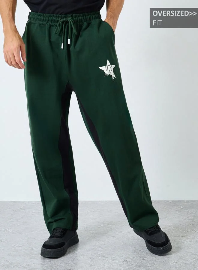 Styli Men Green Graphic Print Oversized Joggers
