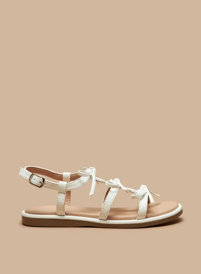 فلورا بيلا من شو إكسبرس Girls Bow Accent Flat Sandals with Buckle Closure