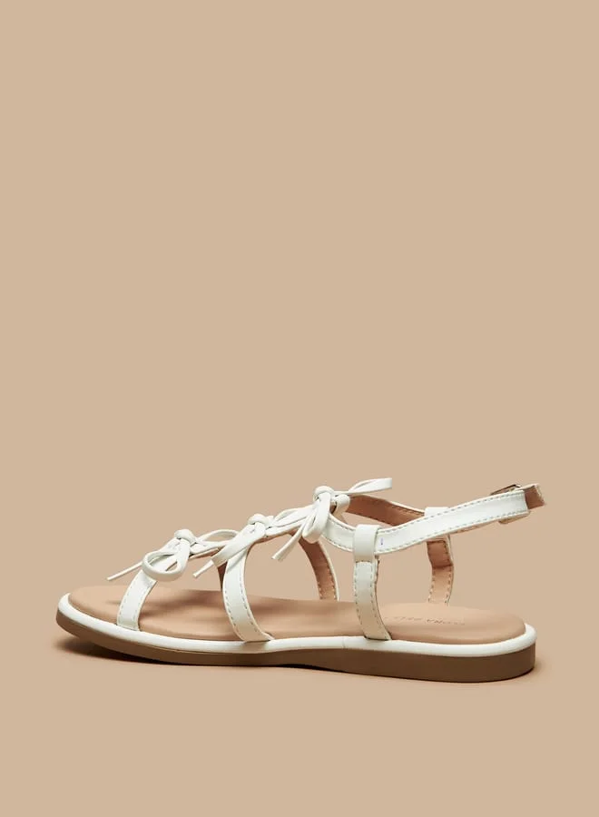 فلورا بيلا من شو إكسبرس Girls Bow Accent Flat Sandals with Buckle Closure
