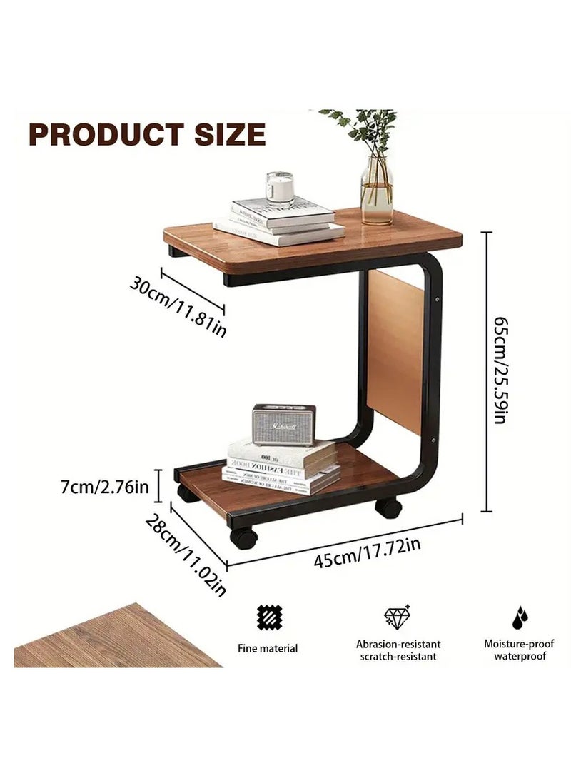 Generic Movable side table with C-shaped wheels, Gemini brown wooden top and durable black metal frame. Multi-functional. Includes a lower shelf for extra storage space and a side pocket for storing bill envelopes, notebooks, magazines or charging cable. Elegant and simple design, space-saving and easy to move thanks to the wheels. Lightweight and fits most decors and blends easily with other furniture. Practical for using a laptop, placing a phone, a coffee cup or TV remote, eating a snack or reading a book. You can place it next to the bed, in the living room, in the office to place a coffee tray or in the kitchen. Can be used as a kitchen cart  - Image 4