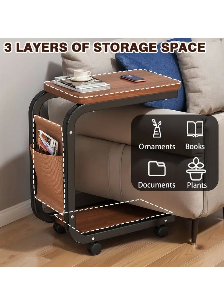Generic Movable side table with C-shaped wheels, Gemini brown wooden top and durable black metal frame. Multi-functional. Includes a lower shelf for extra storage space and a side pocket for storing bill envelopes, notebooks, magazines or charging cable. Elegant and simple design, space-saving and easy to move thanks to the wheels. Lightweight and fits most decors and blends easily with other furniture. Practical for using a laptop, placing a phone, a coffee cup or TV remote, eating a snack or reading a book. You can place it next to the bed, in the living room, in the office to place a coffee tray or in the kitchen. Can be used as a kitchen cart  - Image 5