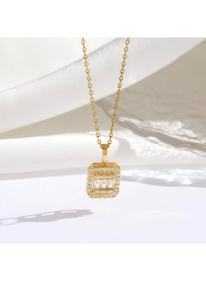 Luxuria The Baguette Pendant features a modern design that combines simplicity and luxury. The pendant consists of a central stone or a group of stones in a rectangular baguette setting, surrounded by a frame of small, shimmering stones that create a halo effect, enhancing its brilliance and visual impact. - Image 1