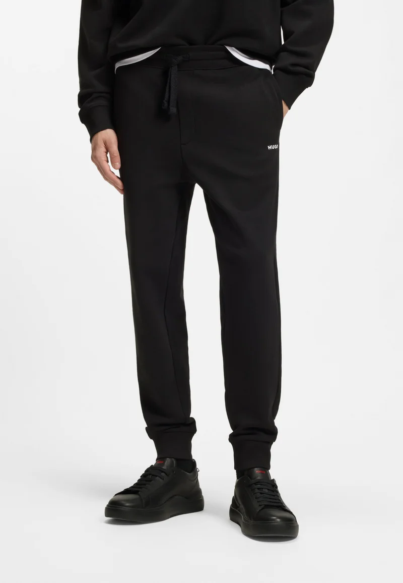 HUGO Cuffed tracksuit bottoms in cotton terry with logo print