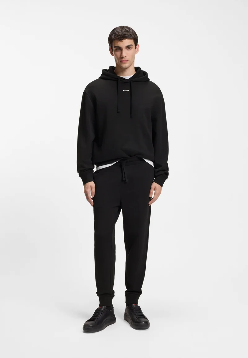 HUGO Black Cuffed tracksuit bottoms in cotton terry with logo print for Men | Best Price UAE