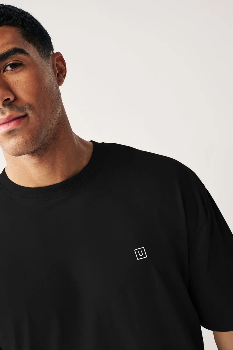 Urbano Fashion  Urbano Fashion Men's Jet Black Solid Round Neck Oversized Half Sleeve Cotton T-Shirt  | Best Price UAE