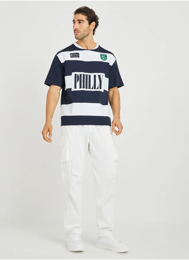ستايلي Styli Text Print Micro Pique Boxy Fit Varsity T-Shirt