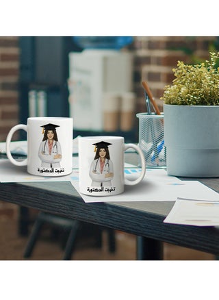 مج من السيراميك بطبعة تصميم "تخرجت الدكتورة" بلون أبيض - pzsku/ZD6BA90D81844DBFED543Z/45/_/1730201447/eb437edf-31d6-4a20-b101-a7386e73aeb1
