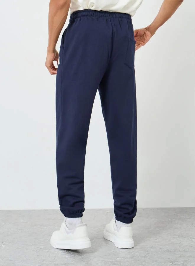 Styli Men Heavy Fleece Joggers with Badge Detail