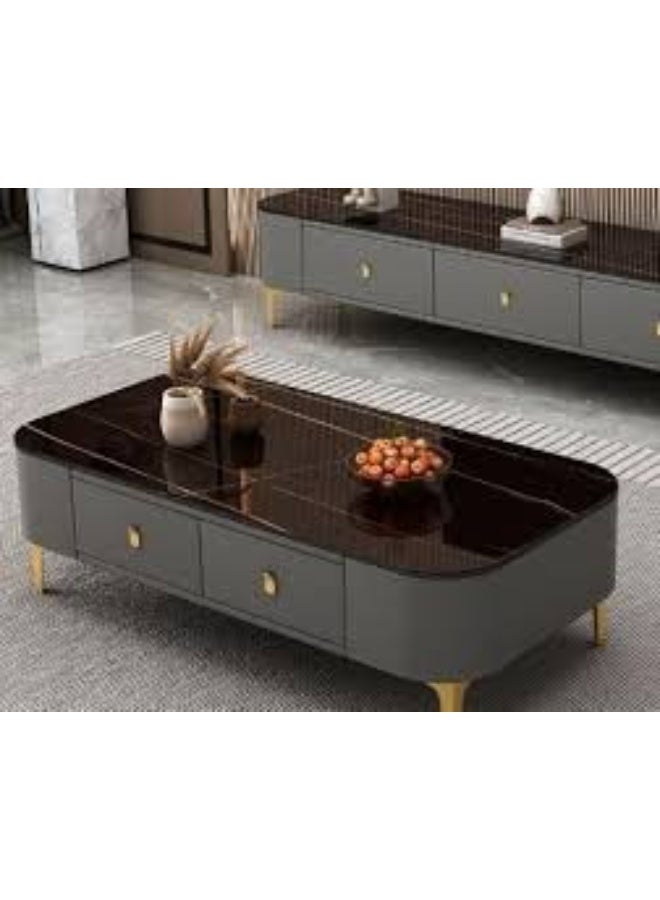 Modern rectangular coffee table featuring a Black faux-marble tabletop, gray upholstered storage drawers, and gold legs. - Image 1