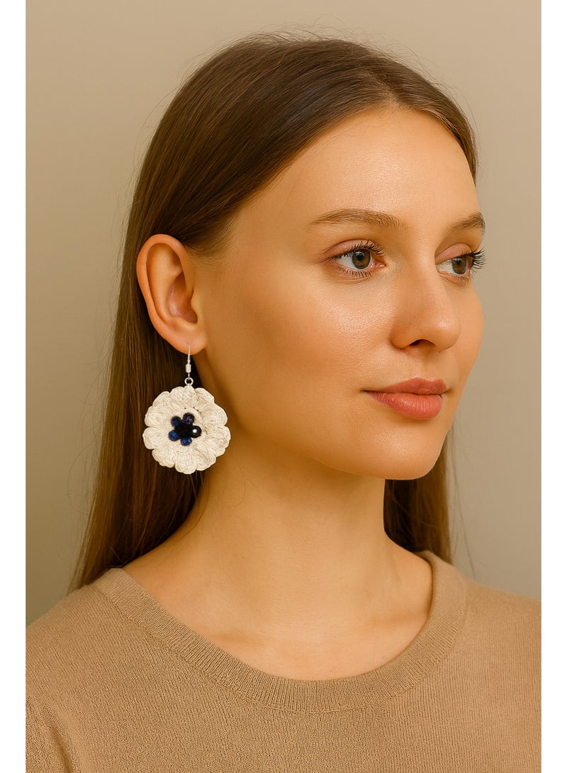Lolly Handmade Crochet Flower Earrings – These beautiful earrings feature a large, intricate flower design made with soft, high-quality yarn. The white petals are complemented by a deep blue  center, creating a striking, yet elegant accessory. Perfect for adding a touch of floral charm to any outfit, whether you're dressing up for a special occasion or adding flair to your daily look - Image 1