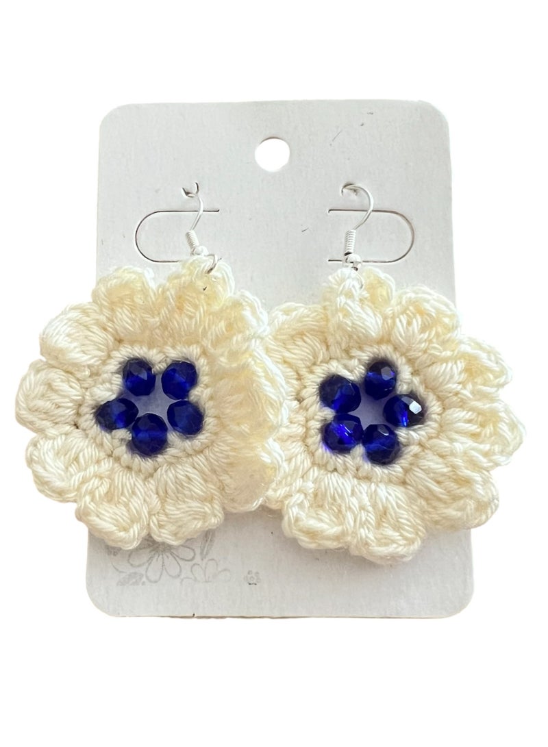 Lolly Handmade Crochet Flower Earrings – These beautiful earrings feature a large, intricate flower design made with soft, high-quality yarn. The white petals are complemented by a deep blue  center, creating a striking, yet elegant accessory. Perfect for adding a touch of floral charm to any outfit, whether you're dressing up for a special occasion or adding flair to your daily look - Image 2