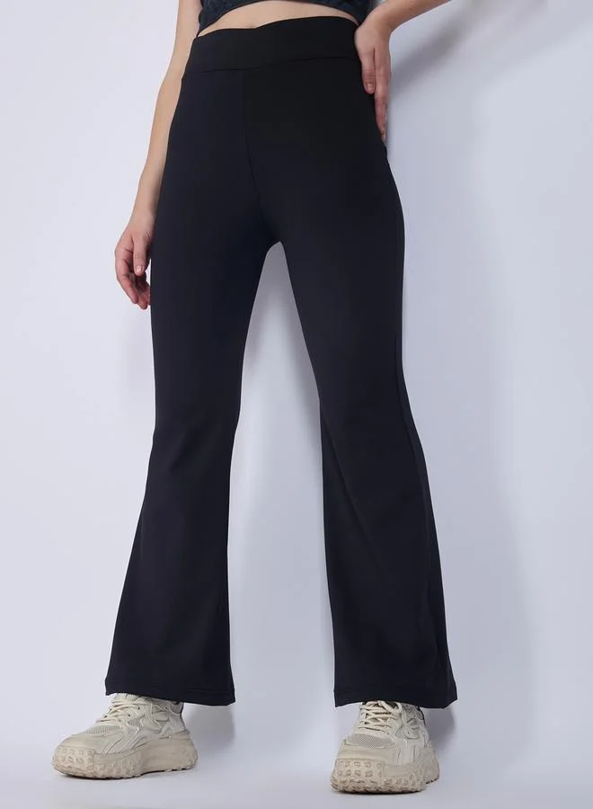 Outzidr  Black Criss Cross Waistband Flared Leggings for Women | Best Price UAE