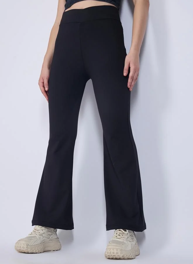 Outzidr  Black Criss Cross Waistband Flared Leggings for Women | Best Price UAE