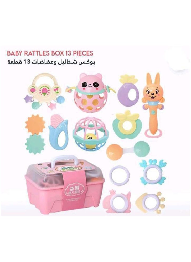 null - A box containing 13 pieces of silicone rattles and teethers in cheerful shapes and colors that help develop your child's skills. - Image 1