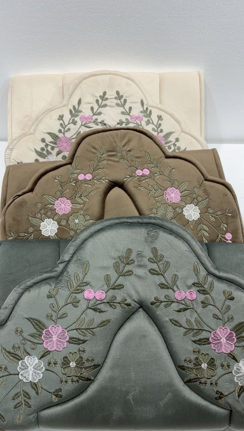 Two embroidered prayer rugs set with a free third rug in an elegant design
