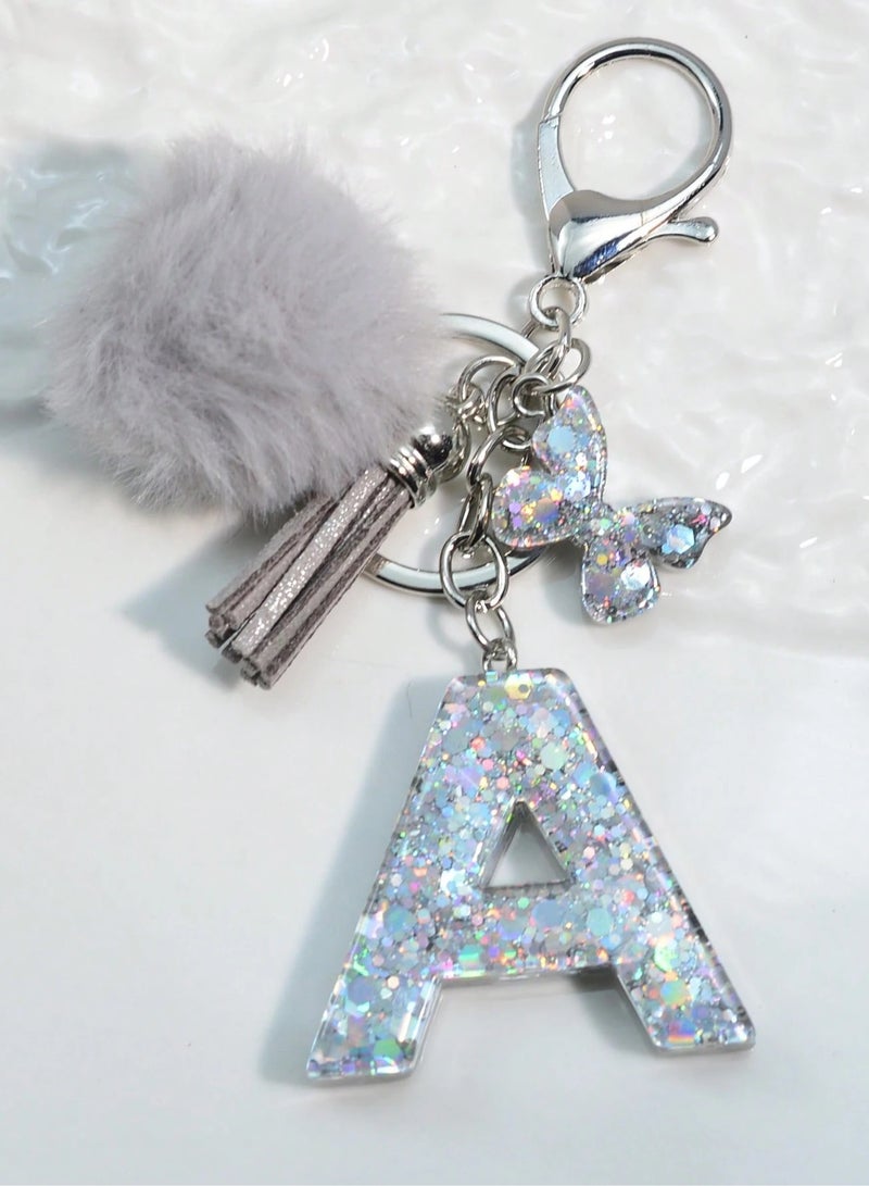 Generic Keychain featuring the letter "A" with a soft pom-pom and a butterfly charm. Can be used as a keyring or bag accessory. 