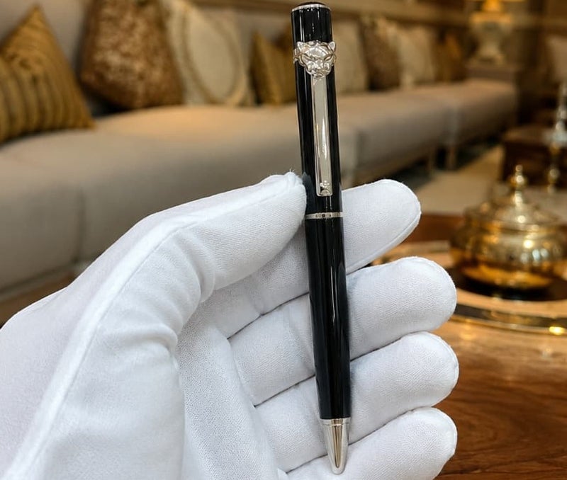 A ballpoint pen adorned with a panther (tiger) tip.