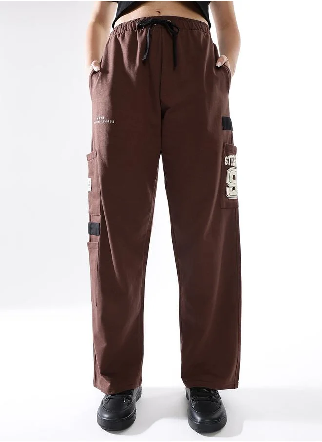 هوبرهولمي Women Track Pants in Brown featuring Jogger fit with a printed pattern, no sleeves, regular length, secured with elasicated + drawstring closure, crafted from terry – an essential addition to your stylish collection.
