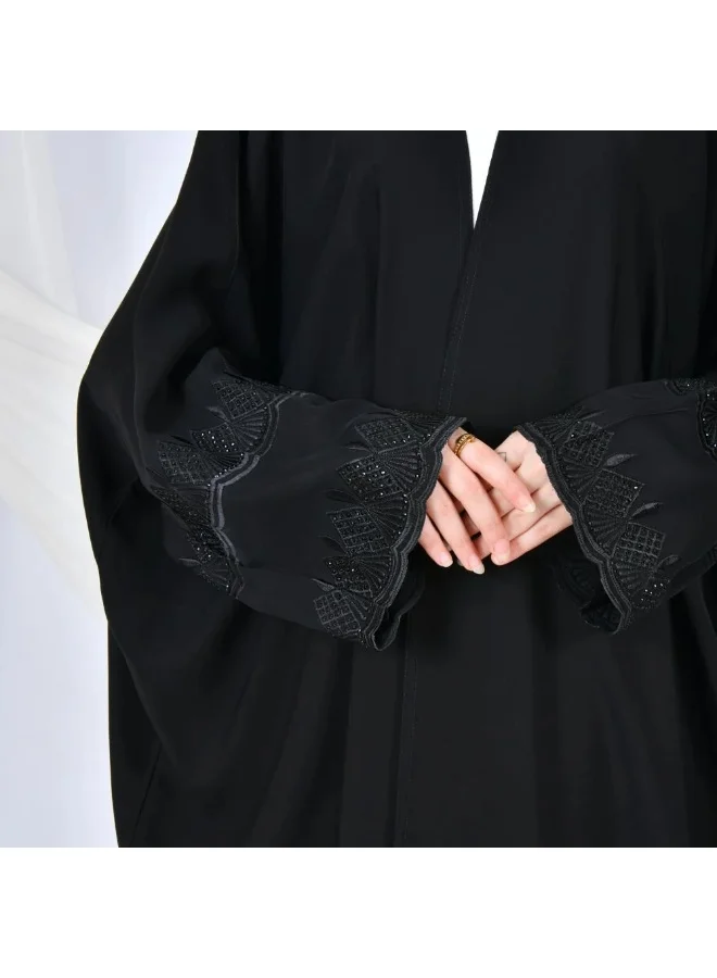 lamha abaya Black abaya with a quarter-bisht cut and embroidery on the sleeves