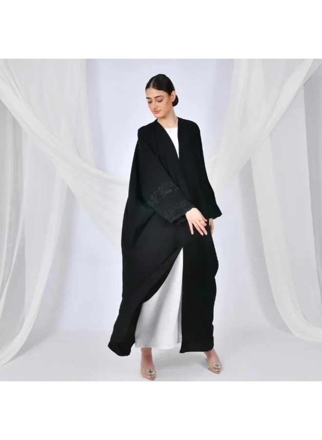 lamha abaya Black abaya with a quarter-bisht cut and embroidery on the sleeves