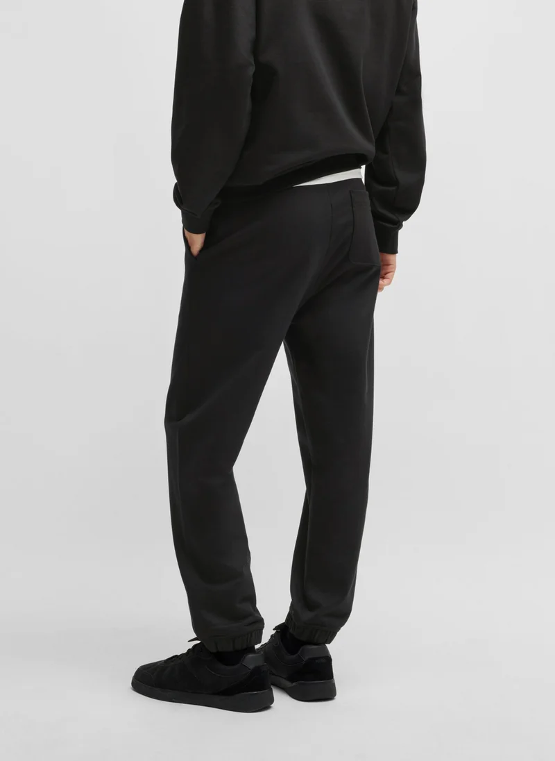 HUGO Cotton-terry tracksuit bottoms with smoke logo