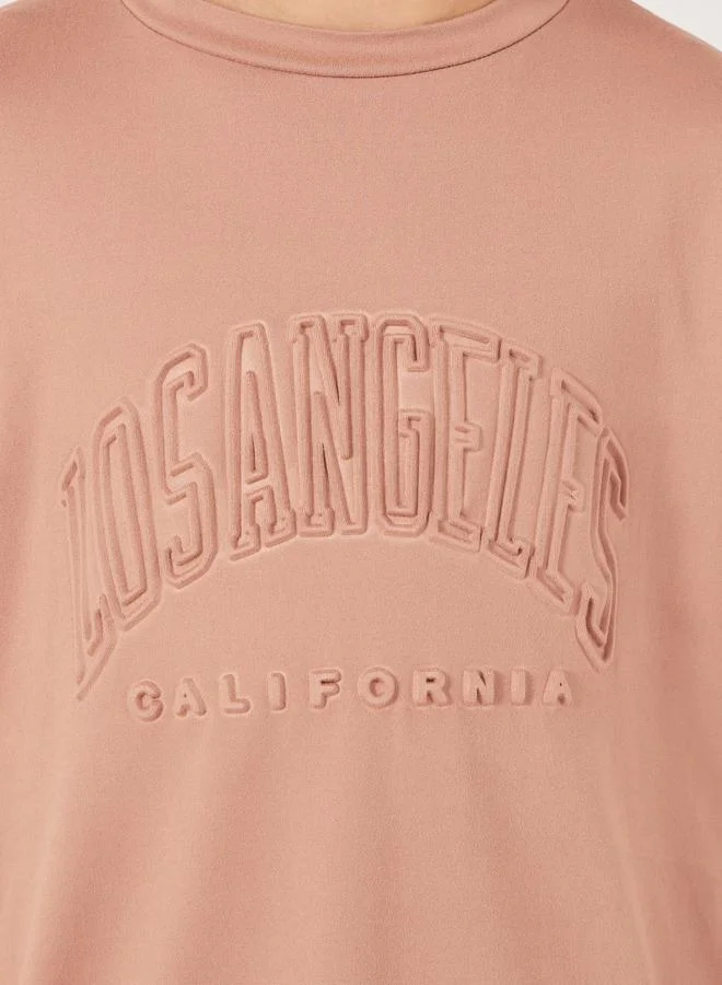 Styli Embossed Slogan Round Neck Oversized T-Shirt