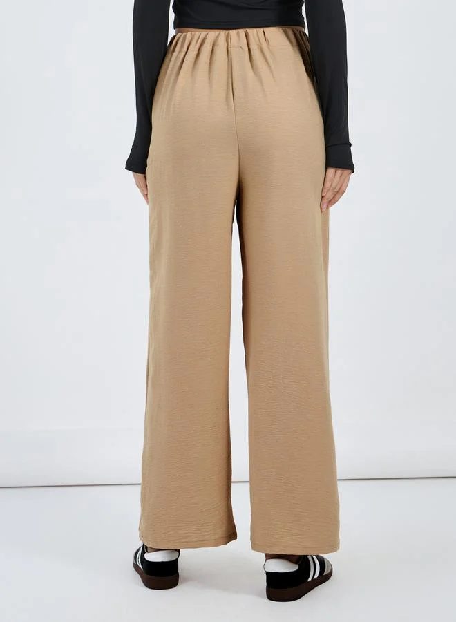 Styli Textured Mid Rise Wide Leg Pants with Badge Detail