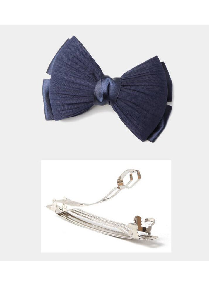 "Bow hair clip with satin ribbon in navy blue, a soft touch that adds femininity and beauty to your look."