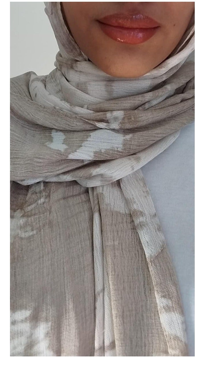 Luxuria This olive and off-white safari tie-dye linen scarf features a modern design that combines simplicity and elegance. Made from a soft, lightweight, and flowing fabric, it provides all-day comfort and is easy to wrap and stay in place, making it suitable for various everyday and casual looks. - Image 1