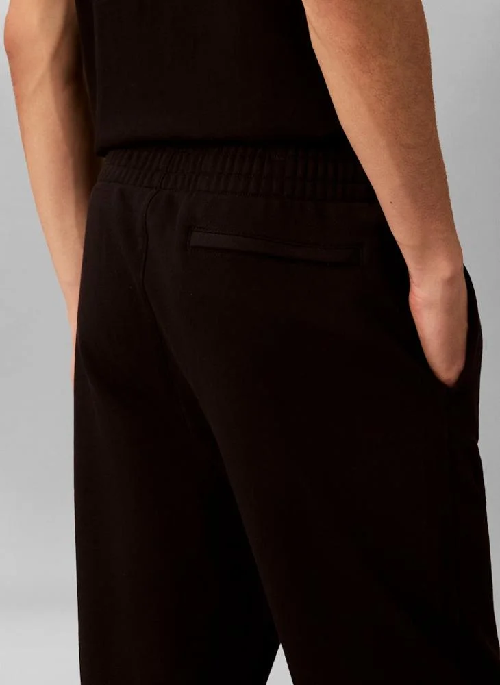 Calvin Klein Jeans Black Relaxed Cotton Terry Joggers for Men | Best Price UAE