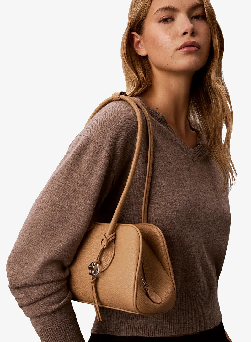 Calvin Klein Tannin Emblem Pebble Grain Extended Side Shoulder Bag for Women | Best Price UAE