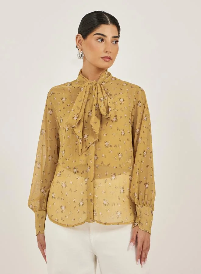 Styli Floral Print Textured Tie-Up Neck Blouse