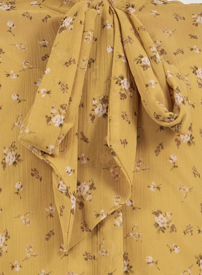 Styli Floral Print Textured Tie-Up Neck Blouse