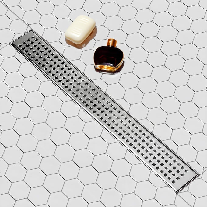 24 INCH LINEAR SHOWER DRAIN WITH REMOVABLE SQUARE HOLE PANEL BY USING BRUSHED 304 STAINLESS STEEL PROCESS LINEAR DRAIN EQUIPPED WITH ADJUSTABLE FEET AND HAIR STRAINER