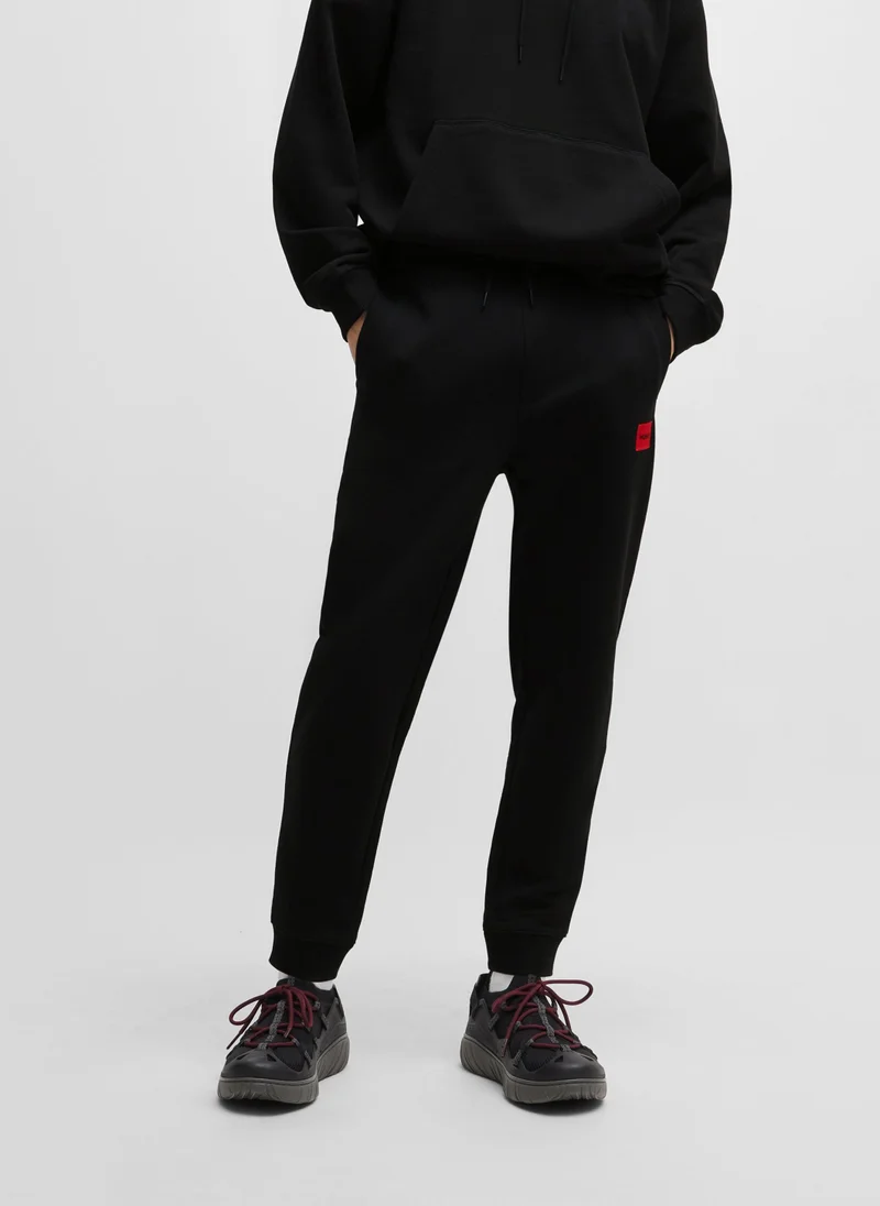 HUGO Cotton-terry tracksuit bottoms with red logo label