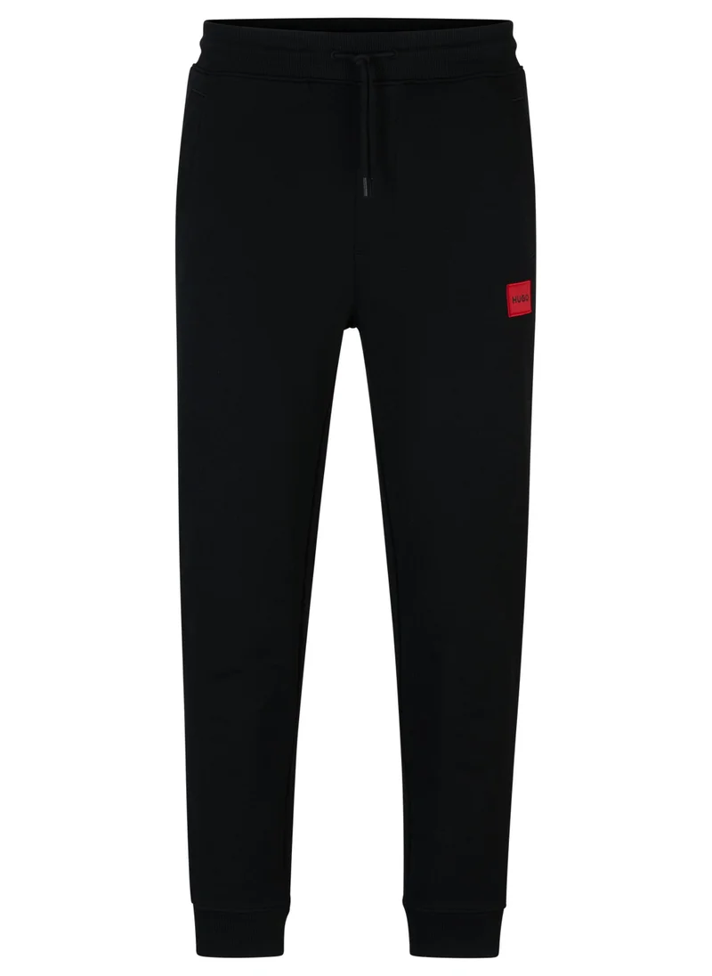 HUGO Cotton-terry tracksuit bottoms with red logo label