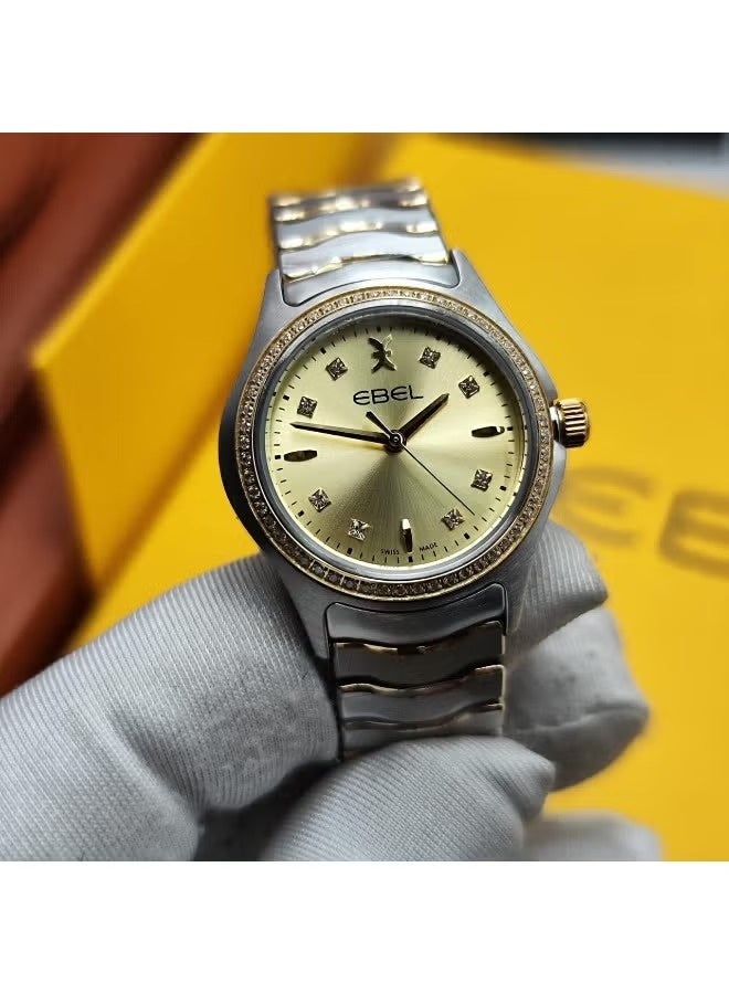 The Ebel women's watch features a classic design with a distinctive wave-shaped strap.