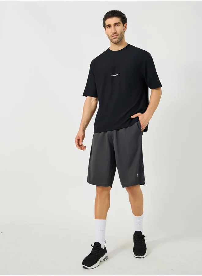 ستايلي Mesh Insert Oversized Training Shorts with Badge Detail