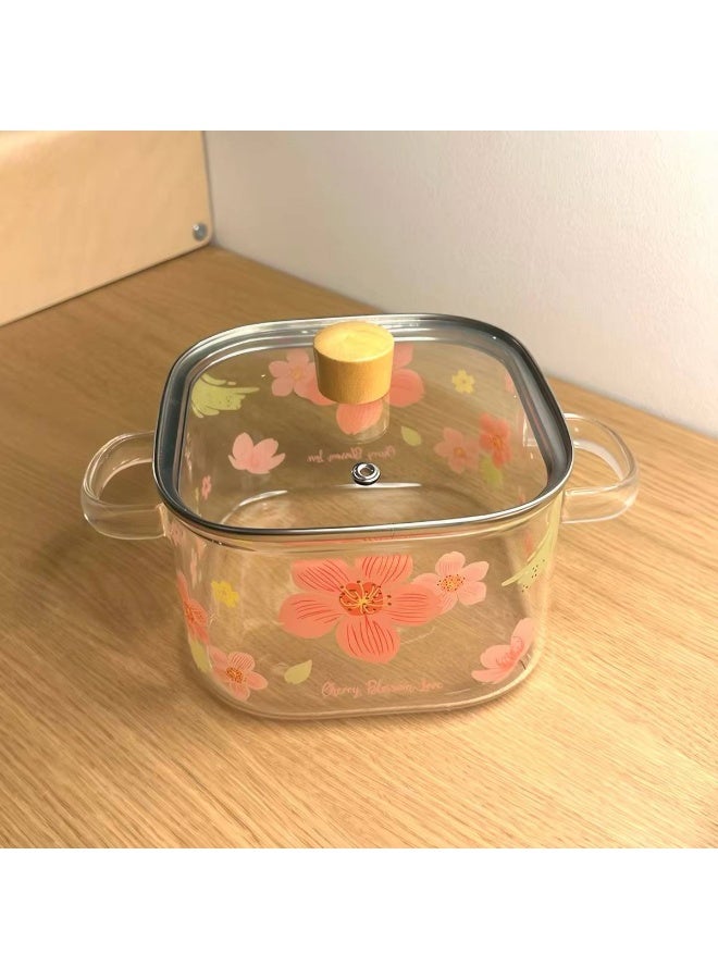 A stockpot with a tight-fitting glass lid featuring an elegant Cherry Blossom Love, suitable for both cooking and serving. - Image 3