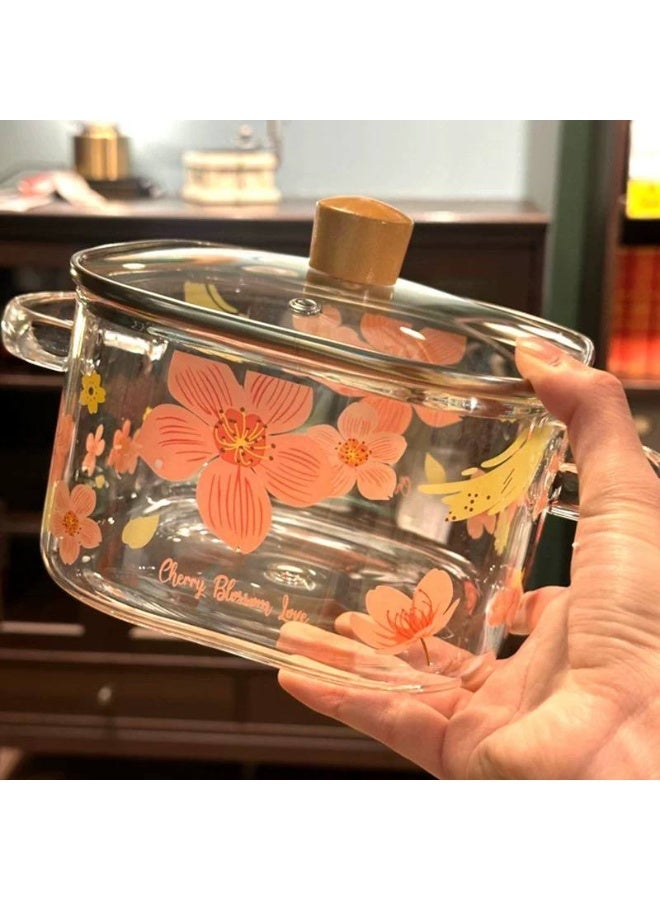A stockpot with a tight-fitting glass lid featuring an elegant Cherry Blossom Love, suitable for both cooking and serving. - Image 1