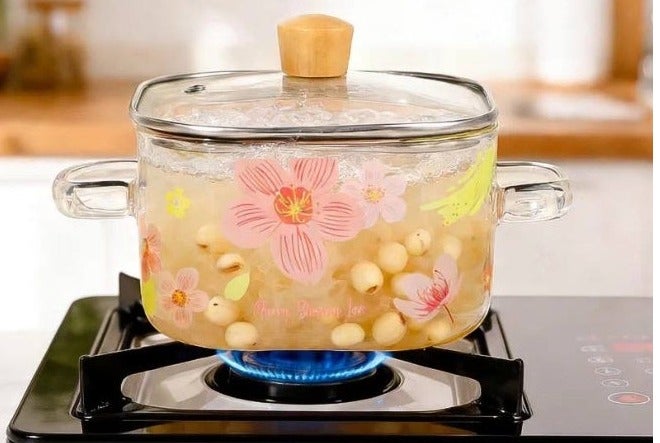 A stockpot with a tight-fitting glass lid featuring an elegant Cherry Blossom Love, suitable for both cooking and serving. - Image 2