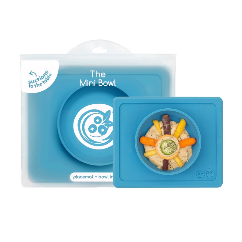 ezpz Mini Bowl for 12 Months+ (Blue) - 100% Silicone Suction Bowl with Built-in Placemat for Toddlers - Comes with a Reusable Travel Bag - Image 1