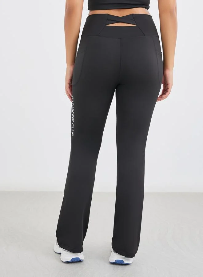 Styli Gymspire Edition - Label Broad Waist Side Pocket Flared Leggings with and Text Detail