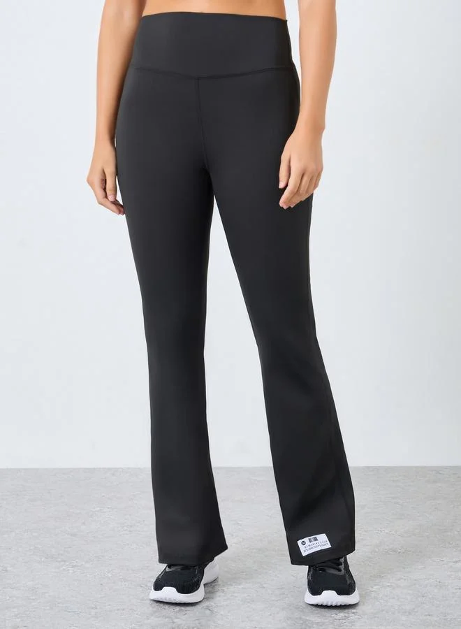 Styli Active Gymspire Edition - Label Broad Waist Side Pocket Flared Leggings with and Text Detail