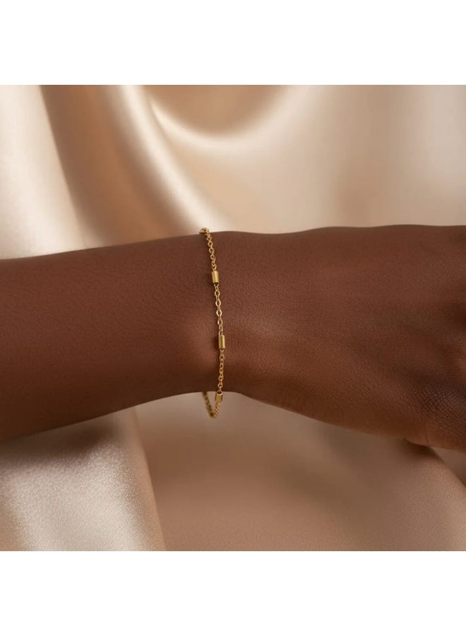 Luxuria A gold chain bracelet with cylindrical beads is a delicate and simple piece of jewelry for women plated with 18-karat gold. It features a simple design that makes it ideal for everyday wear or for pairing with other bracelets. - Image 1