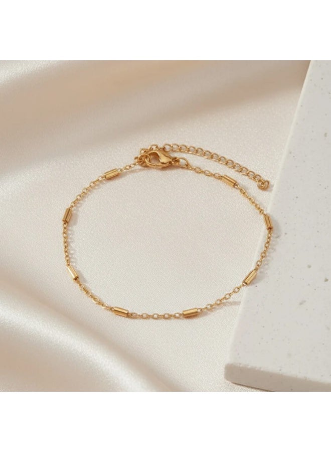 Luxuria A gold chain bracelet with cylindrical beads is a delicate and simple piece of jewelry for women plated with 18-karat gold. It features a simple design that makes it ideal for everyday wear or for pairing with other bracelets. - Image 3