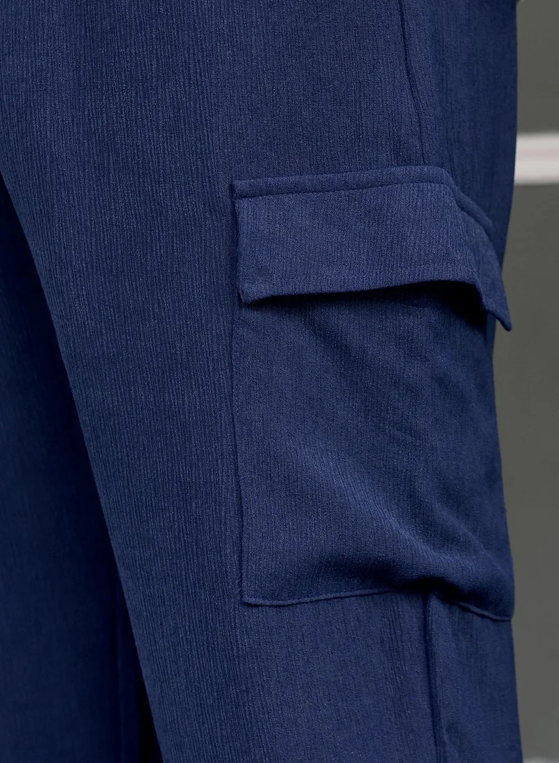 Instafab Plus  Instafab Plus Men Pleated-Textured Cargo Trousers | Mid-Rise , Side Elasticated Stretch | Button Closure , Cuffed-Straight Hem | Solid Textured | Woven Fabric For Casual & Street Wear | Navy Blue for Men | Best Price UAE